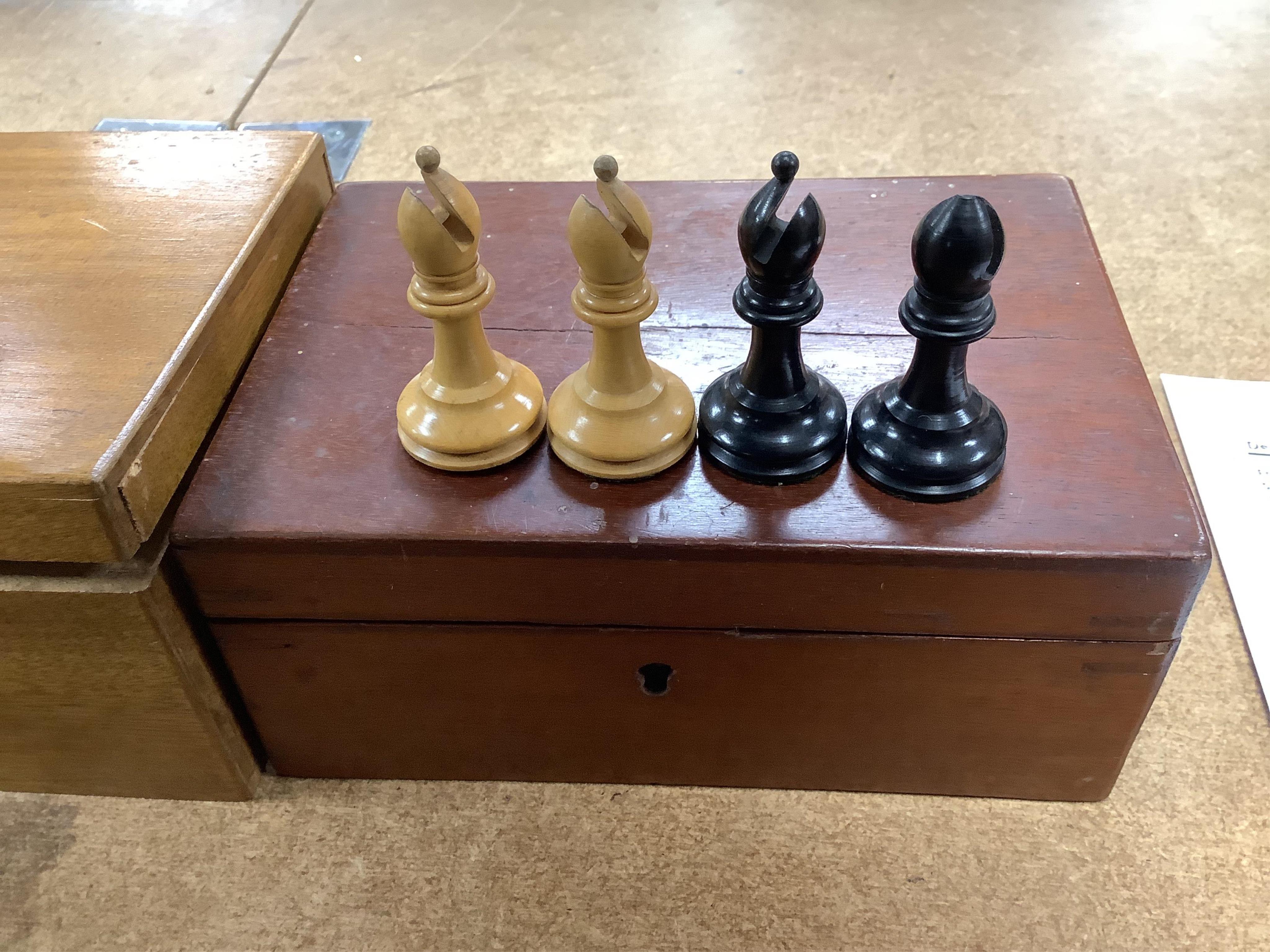 A chess set, possibly F H Ayres, in a mahogany box, and another larger weighted chess set, in box, Ayres Kings 6cm. Condition - good